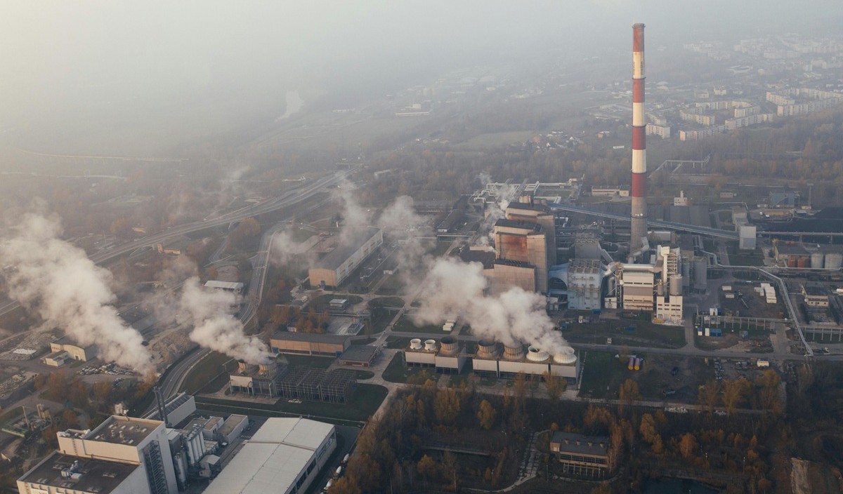 Aerial view of industrial facility with emission stacks for decarbonization analytics
