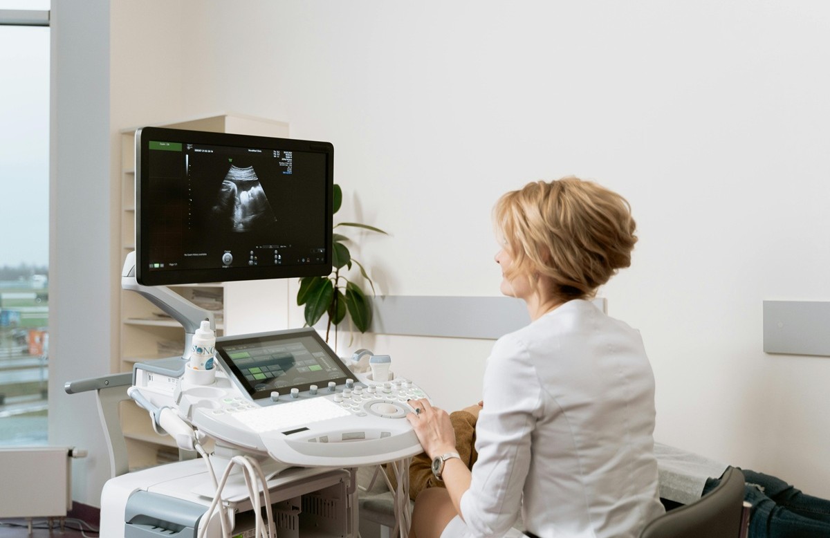 Sonographer analyzing predictive ultrasound imaging on a clinical workstation